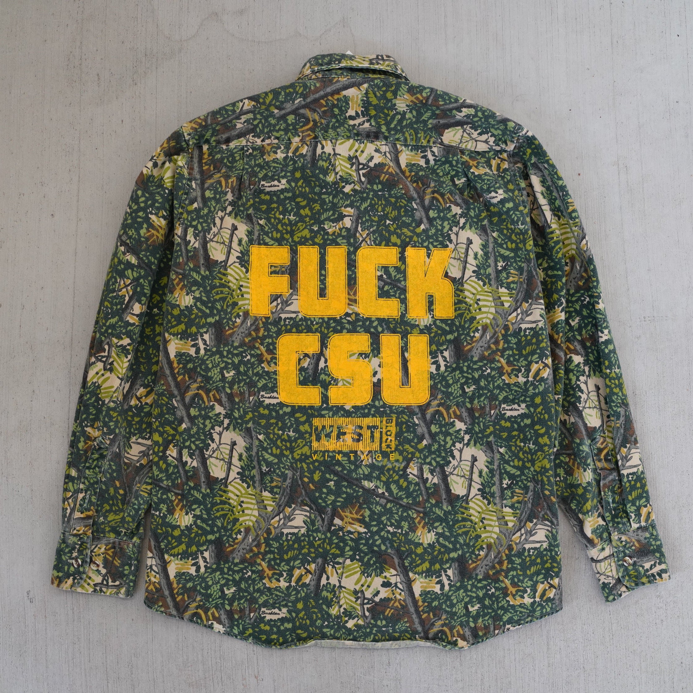 Reworked vintage 1990s Grand Slam Gear forest camo field shirt – handcrafted Wyoming outdoor apparel from the Vintage Wyoming Gear Collection at West Block Vintage.