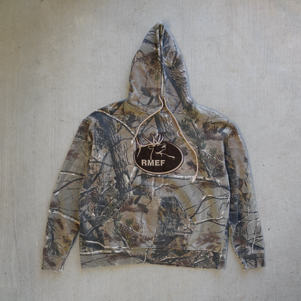 Reworked vintage RMEF Realtree camo hoodie – 2000s style, screen printed in Wyoming, handcrafted outdoor apparel from the Vintage Wyoming Gear Collection at West Block Vintage.