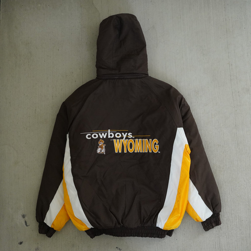 Vintage 1990s Wyoming Cowboys Logo 7 brown and gold winter jacket with embroidered chest and back graphics — Vintage Wyoming Gear Collection, West Block Vintage.