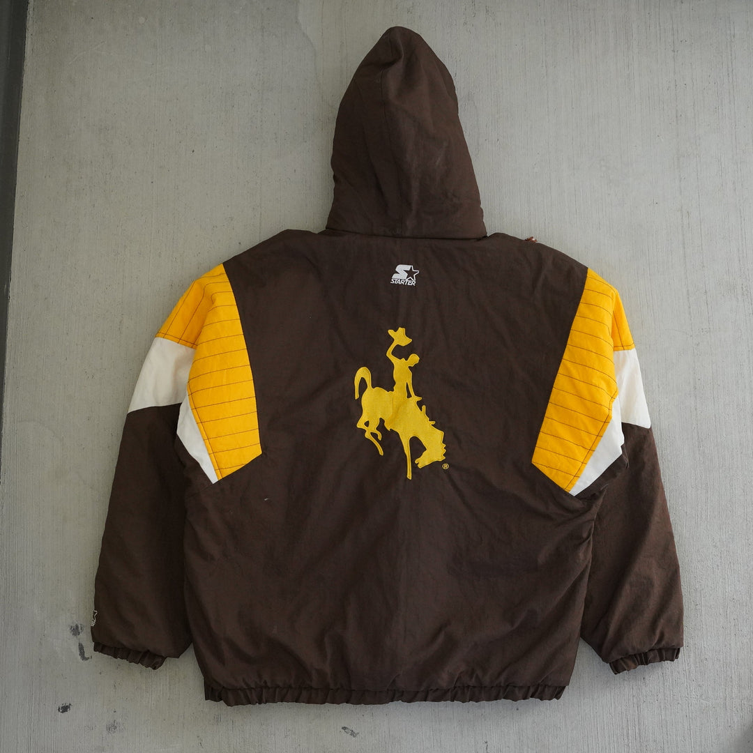 Vintage 1990s Wyoming Cowboys Starter anorak jacket in brown, gold, and white with embroidered logos — Vintage Wyoming Gear Collection, West Block Vintage.