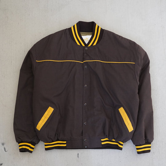 Vintage 1980s Wyoming Cowboys Price bomber jacket in brown and gold with embroidered back logo — Vintage Wyoming Gear Collection, West Block Vintage.