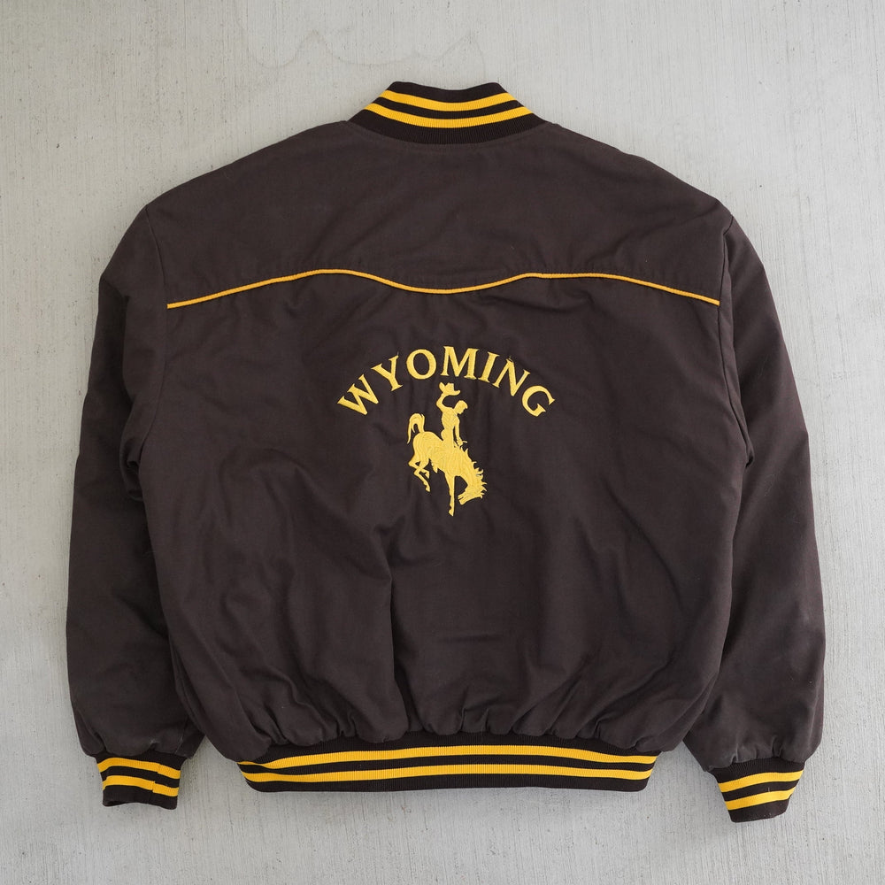 Vintage 1980s Wyoming Cowboys Price bomber jacket in brown and gold with embroidered back logo — Vintage Wyoming Gear Collection, West Block Vintage.