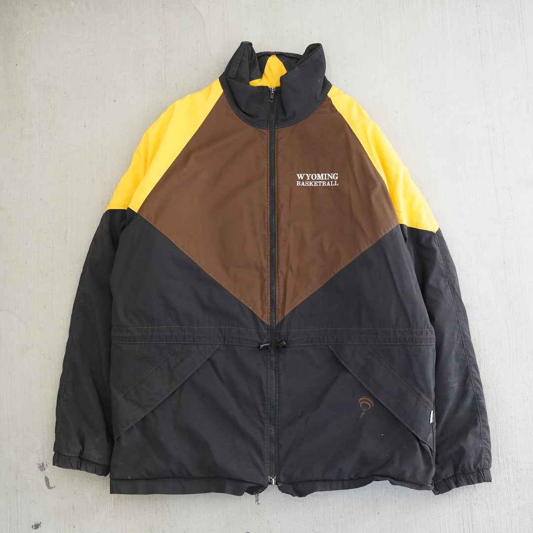 1990s Wyoming Cowboys Basketball warm-up jacket in brown, gold, and black. Vintage UW outerwear from the Vintage Wyoming Gear Collection at West Block Vintage.