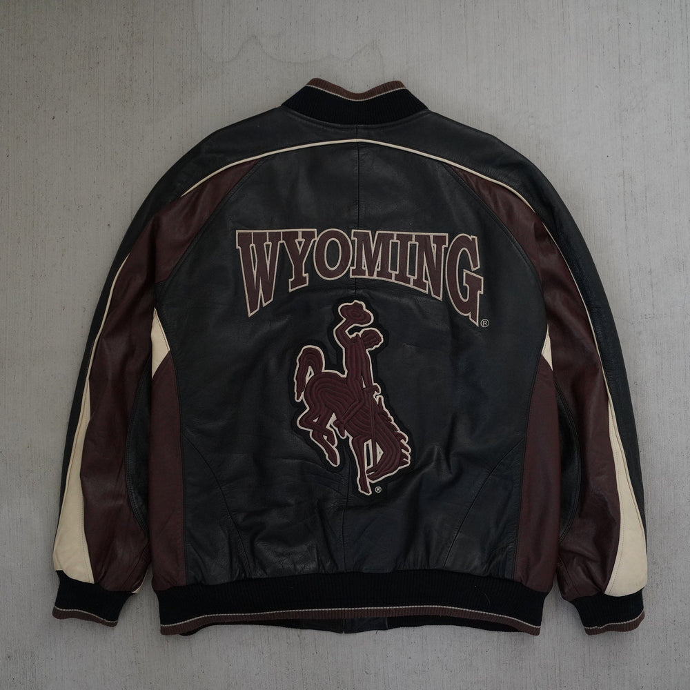 Y2K Wyoming Cowboys full leather jacket in black, maroon, and cream color blocking, size XL, photographed front and back. Vintage sourced, cleaned, and restored in Wyoming. West Block Vintage.