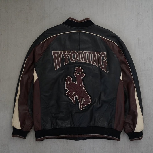Y2K Wyoming Cowboys full leather jacket in black, maroon, and cream color blocking, size XL, photographed front and back. Vintage sourced, cleaned, and restored in Wyoming. West Block Vintage.