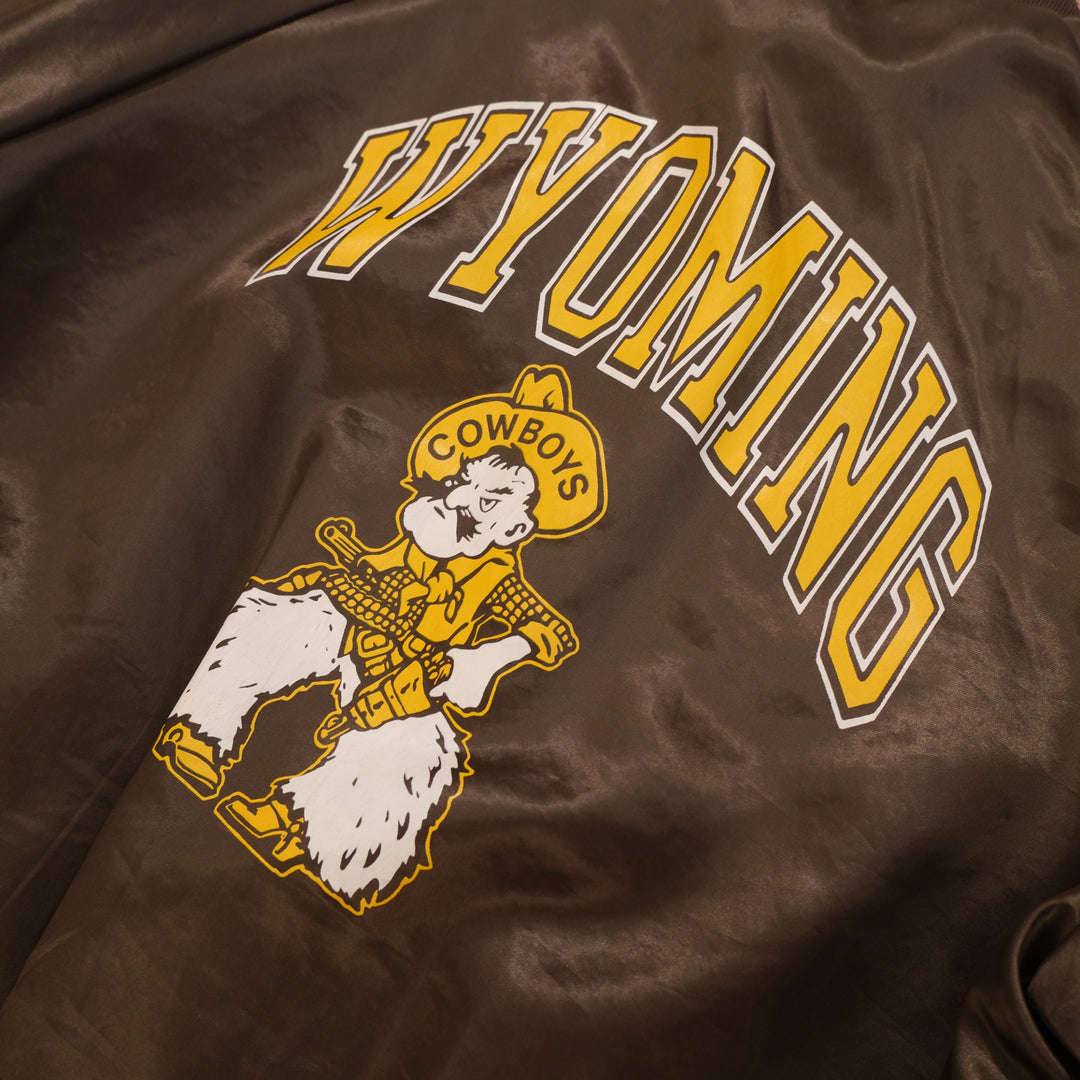 Close-up of arched Wyoming and cowboy mascot screen print on the back of 1980s satin bomber