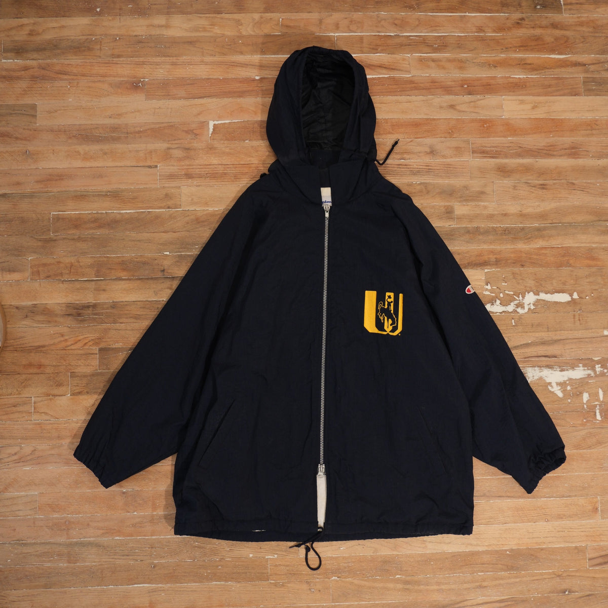 1990s Champion navy Wyoming Cowboys hooded full-zip warm-up jacket with Steamboat chest graphic