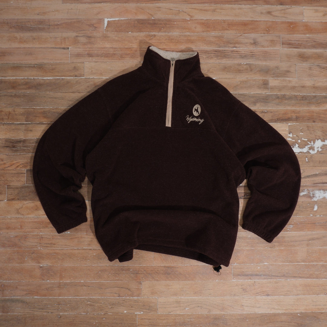 Chocolate brown Y2K Wyoming quarter-zip fleece with cream zipper, small embroidered crest, and adjustable hem