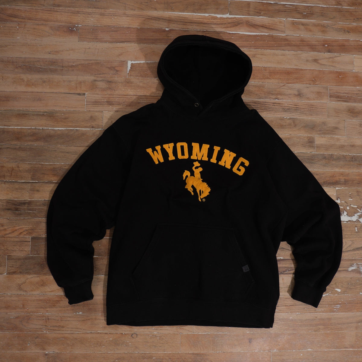 Mid-2000s black Wyoming Cowboys cotton hoodie with gold embroidered Wyoming arch and Steamboat emblem