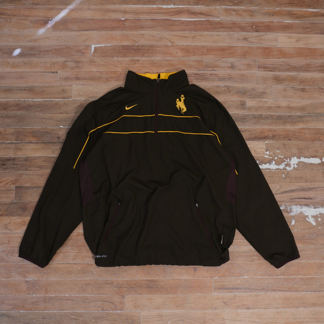 Brown Nike Dri-FIT Wyoming Cowboys full-zip windbreaker with gold piping, Steamboat chest detail, and zippered pockets