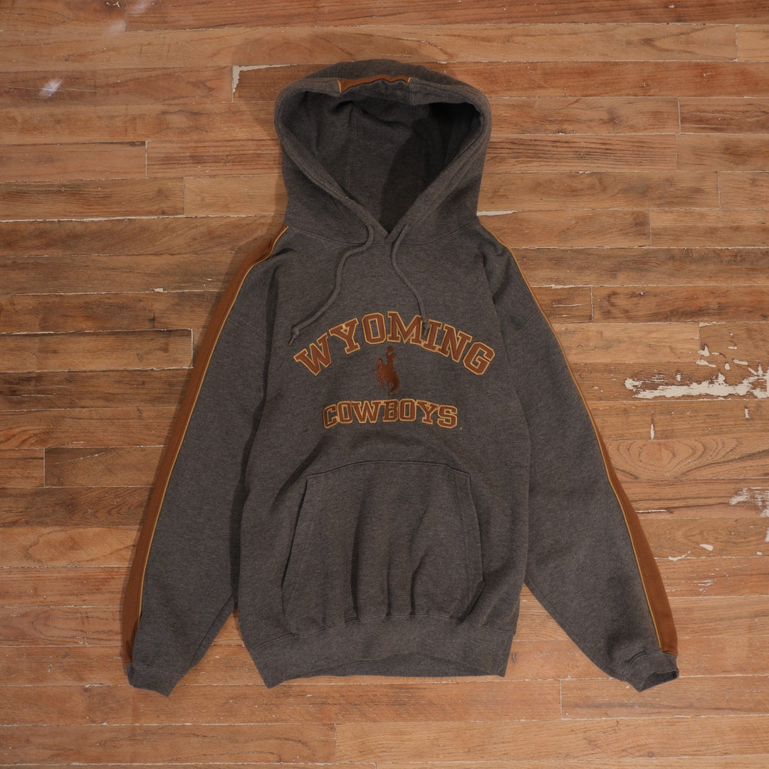 Charcoal gray Wyoming Cowboys embroidered hoodie with rust-brown colorblock sleeves and front kangaroo pocket