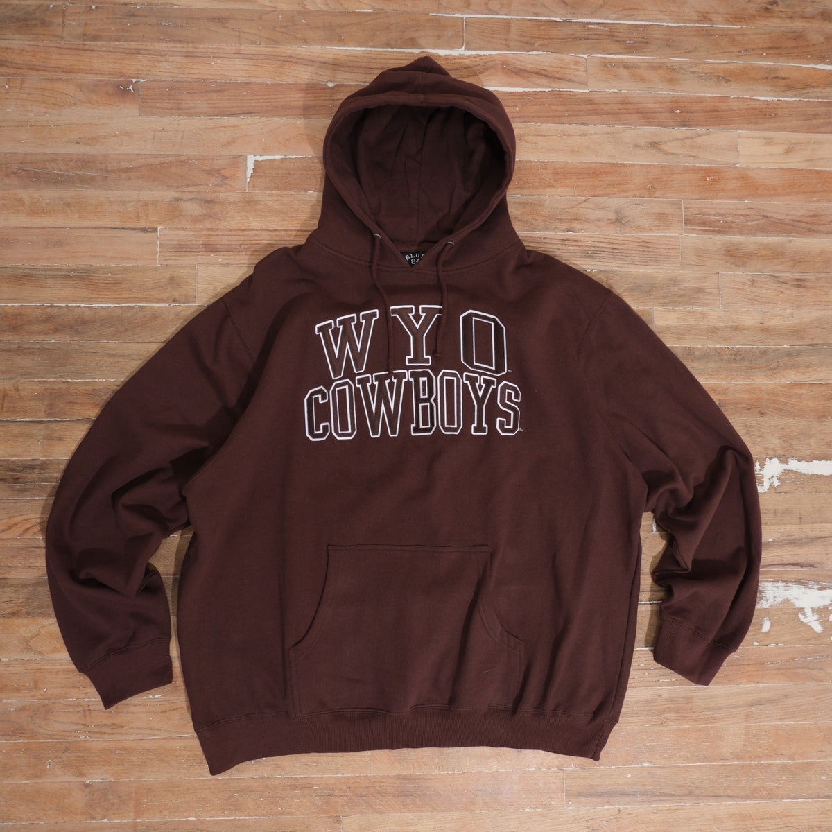 2000s brown 2000s WYO Cowboys Embroidered Brown Hoodie photographed flat on wood floor