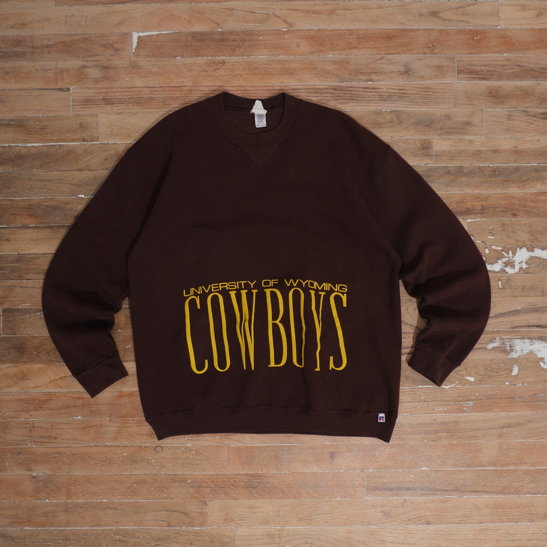 1980s brown / gold 80s University of Wyoming Cowboys Brown Gold Print Crewneck photographed flat on wood floor