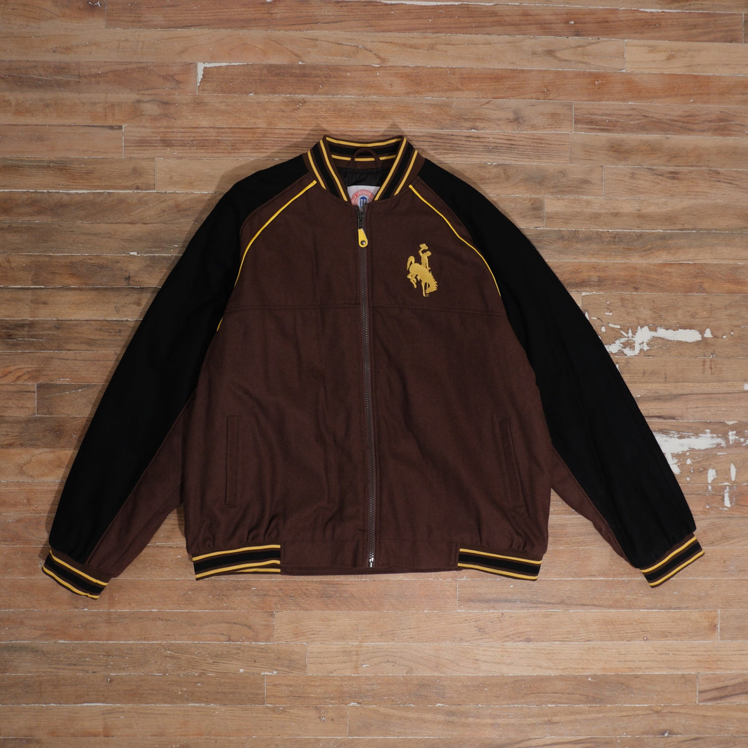 1990s brown / black / gold College Gate Wyoming Cowboys Brown Black Track Jacket photographed flat on wood floor