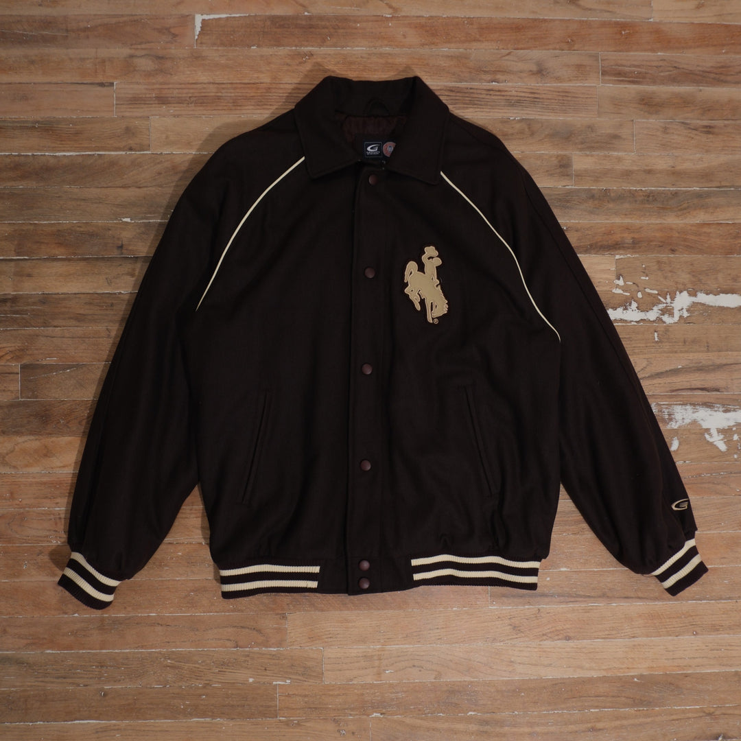 Y2K dark brown / cream / gold Wyoming Cowboys Steamboat Patch Brown Varsity Jacket photographed flat on wood floor