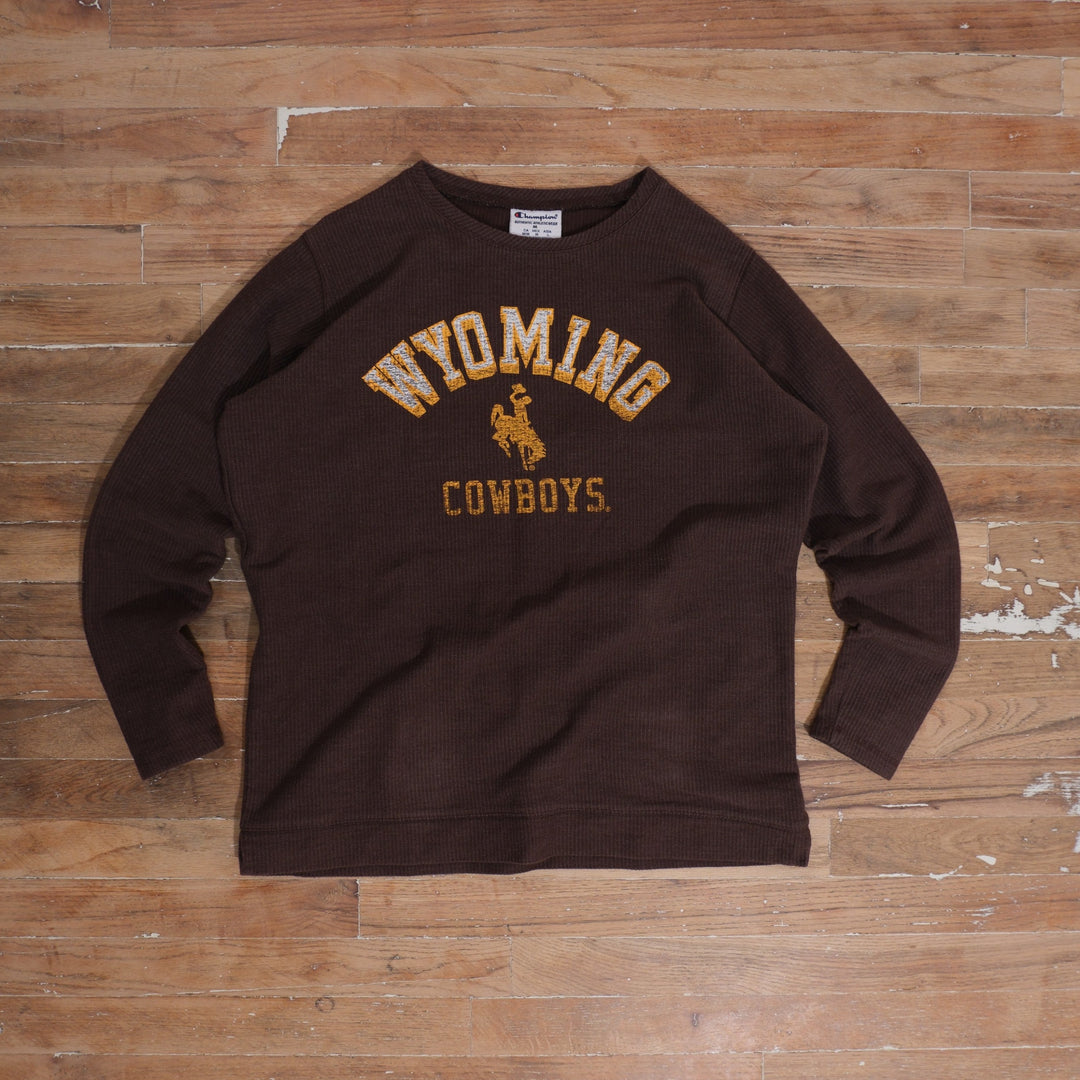 Mid-2000s brown / gold / white Champion Wyoming Cowboys Brown Waffle Knit Thermal Long Sleeve photographed flat on wood floor