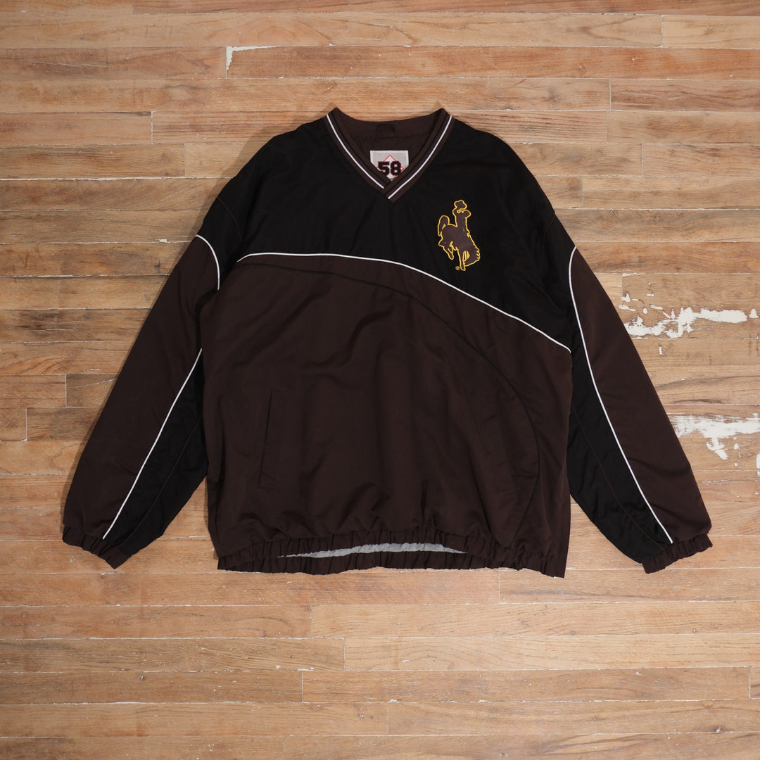 Mid-2000s brown / black / white / gold Wyoming Cowboys Brown Black Colorblock Windbreaker photographed flat on wood floor