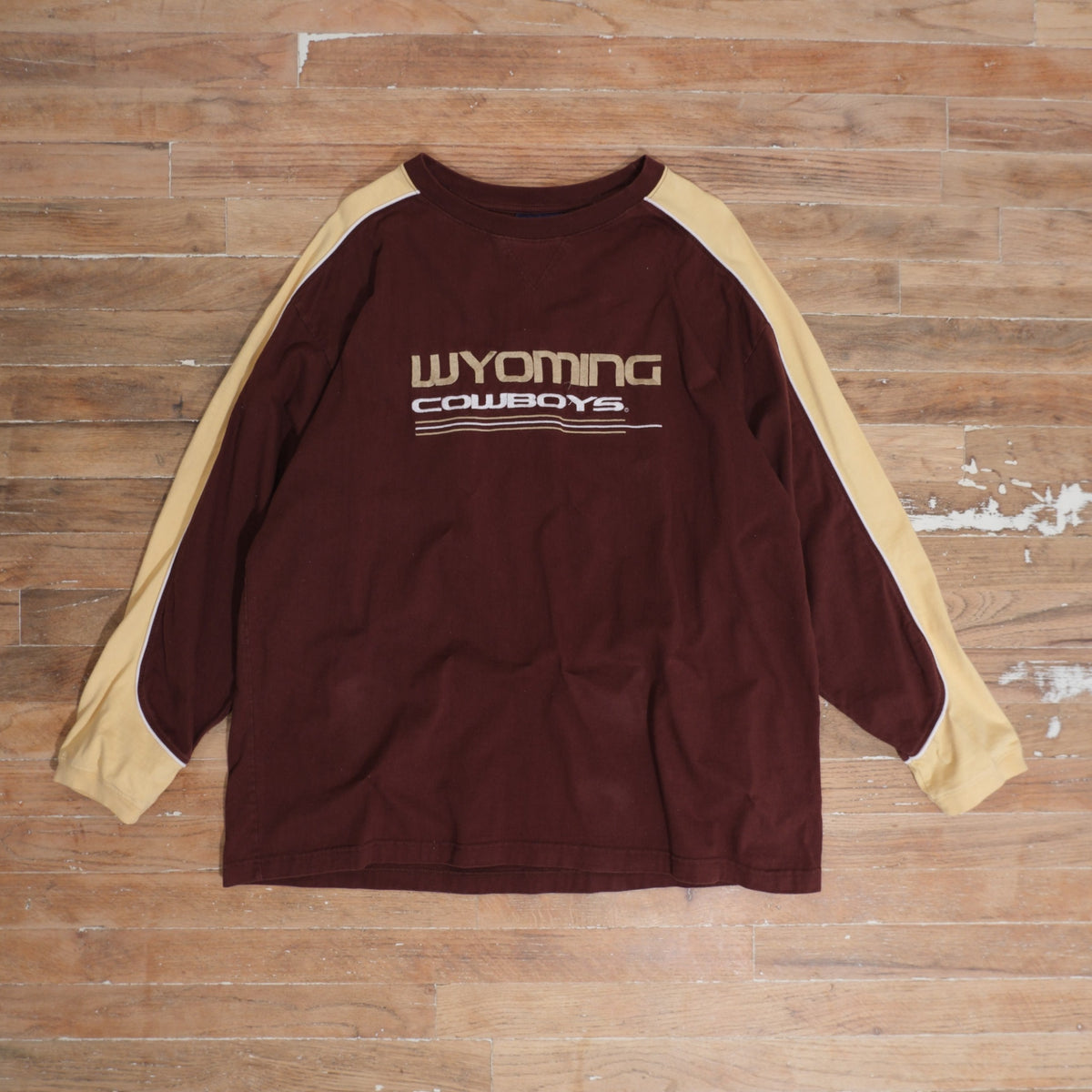 Y2K brown / gold / white Wyoming Cowboys Brown Gold Colorblock Long Sleeve photographed flat on wood floor