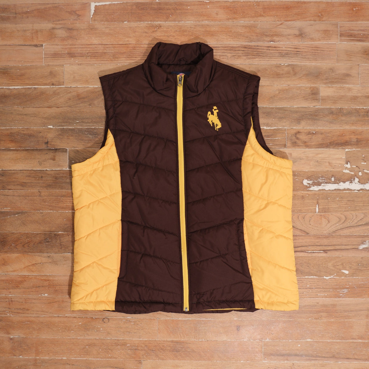 Mid-2000s Wyoming Cowboys brown / gold puffer vest wyoming cowboys brown gold quilted puffer vest front flat lay