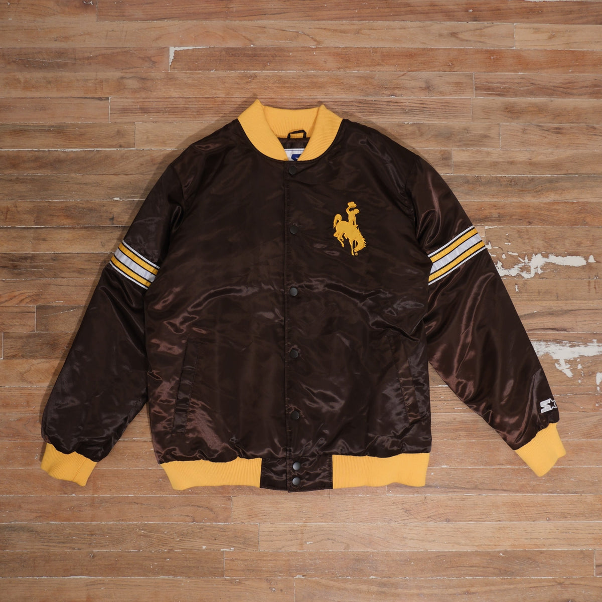2000s Wyoming Cowboys brown / gold bomber jacket starter wyoming cowboys brown gold satin bomber jacket front flat lay