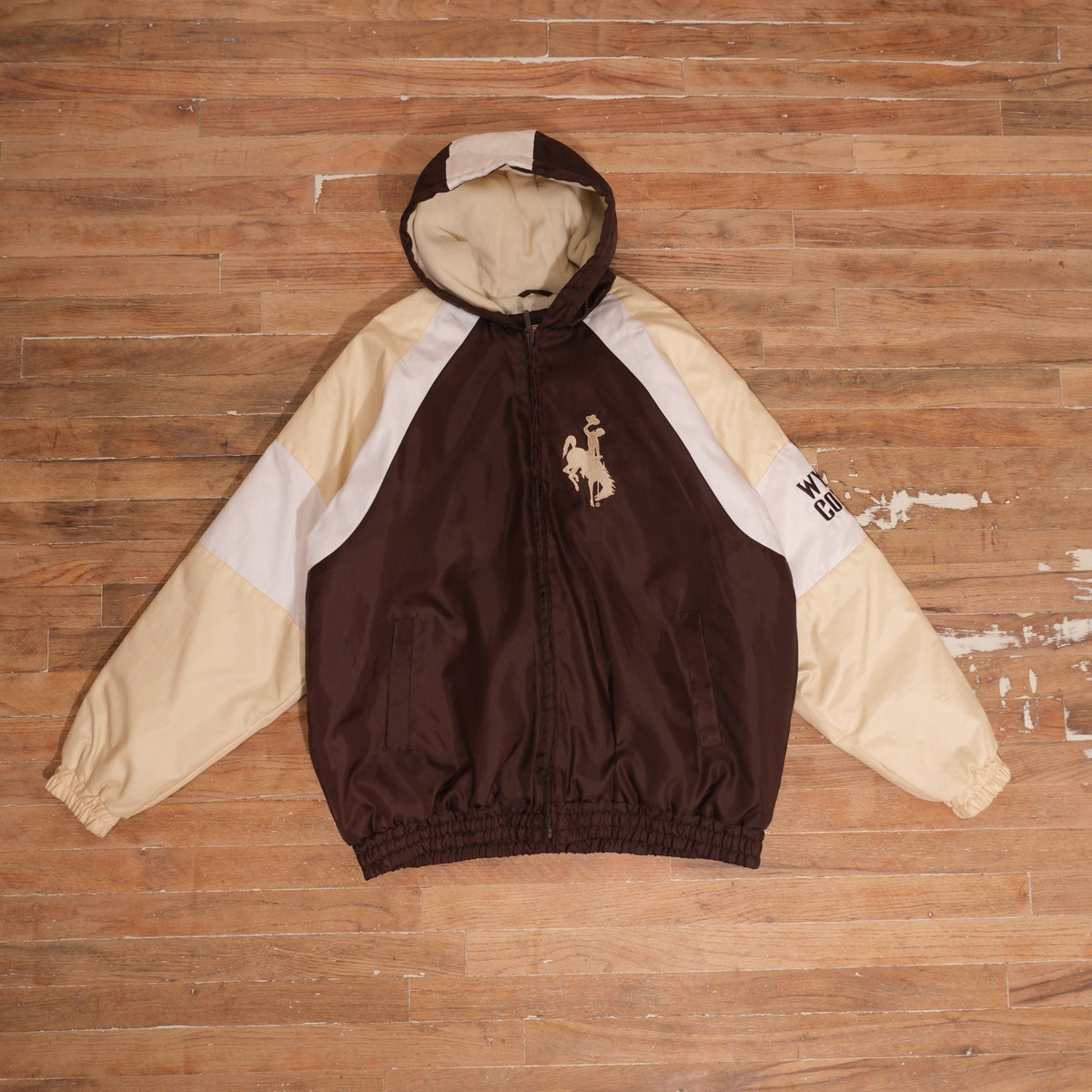 Y2K Wyoming Cowboys brown / cream / white winter jacket wyoming cowboys steamboat brown gold colorblock winter jacket front flat lay