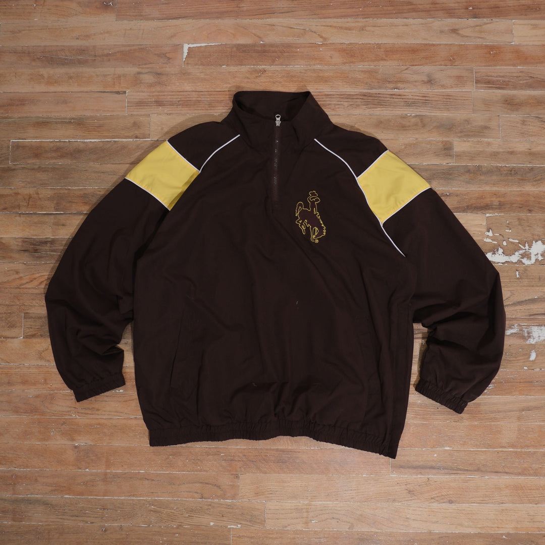 Vintage Y2K Wyoming Cowboys brown quarter-zip windbreaker featuring gold shoulder colorblocking, white piping, Steamboat chest embroidery, front pockets, and elastic cuffs.
