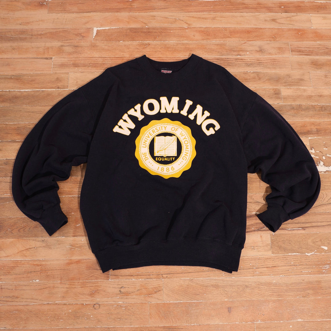 Black Jansport Wyoming Cowboys crewneck with gold and white university seal and arched Wyoming lettering