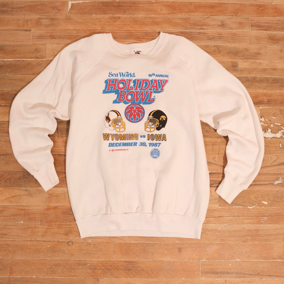 1987 white Wyoming Cowboys versus Iowa SeaWorld Holiday Bowl crewneck with football helmet graphics