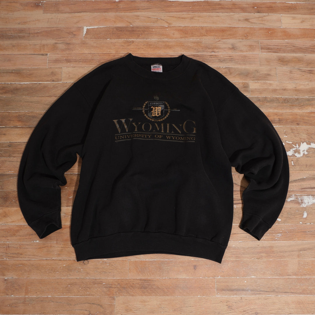 Faded charcoal Oneita Power-Sweats Wyoming Cowboys crewneck with embroidered UW crest and screen-printed university lettering