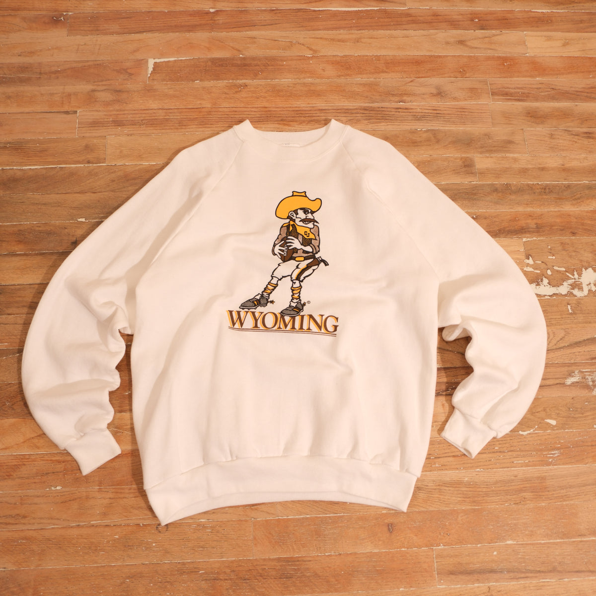 Vintage 1990s Wyoming Cowboy Joe Mascot Raglan Crewneck in white, front view